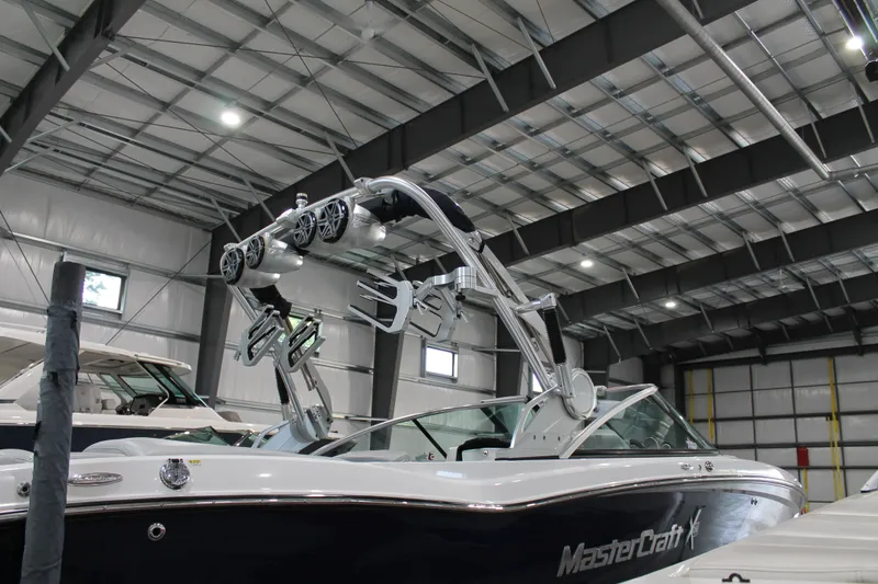 Slide: The Image of 2016 MasterCraft X26 boat in a spacious indoor storage facility. - 5