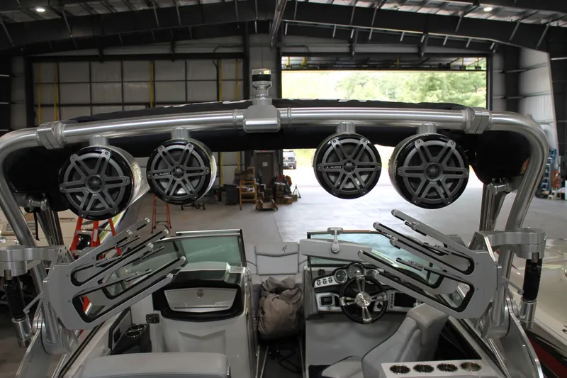 Slide: The Image of 2016 MasterCraft X26 boat interior with speakers and wakeboard racks in a warehouse. - 7