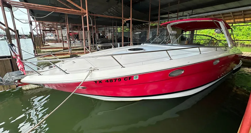 Slide: The Image of 2005 Regal 3350 Sport Cruiser in red docked at marina. - 1