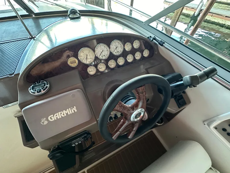 Slide: The Image of 2005 Regal 3350 Sport Cruiser dashboard with Garmin navigation and wood steering wheel. - 16