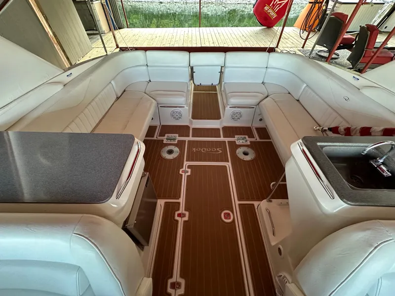 Slide: The Image of 2005 Regal 3350 Sport Cruiser interior with white seating and wood-style flooring. - 19