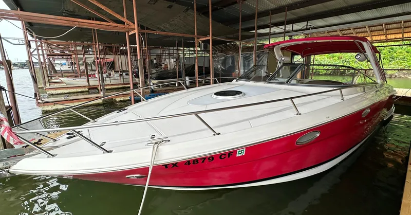 Slide: The Image of 2005 Regal 3350 Sport Cruiser in dock, red and white exterior. - 2