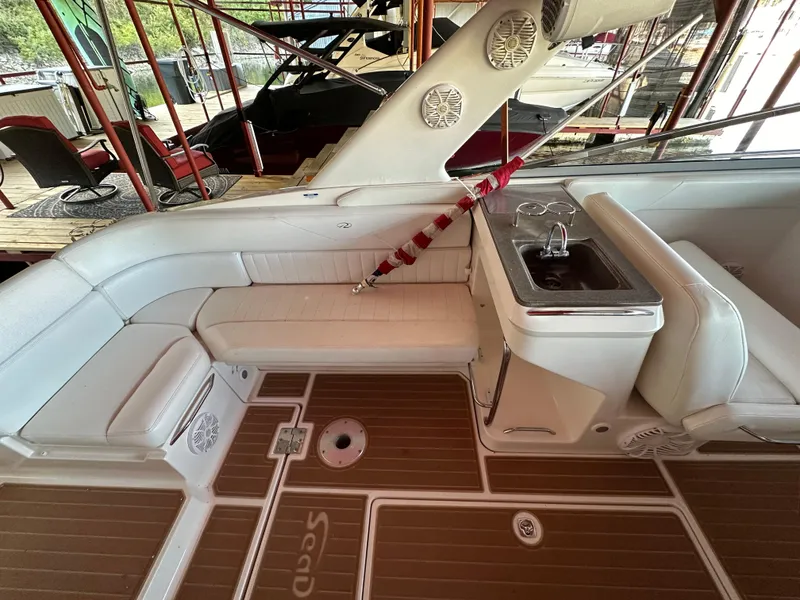 Slide: The Image of 2005 Regal 3350 Sport Cruiser interior with white seating and compact sink. - 20