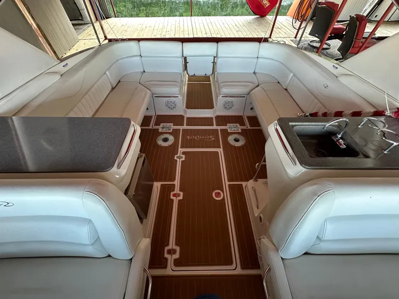 Slide: The Image of 2005 Regal 3350 Sport Cruiser interior with white seating and wood flooring. - 22
