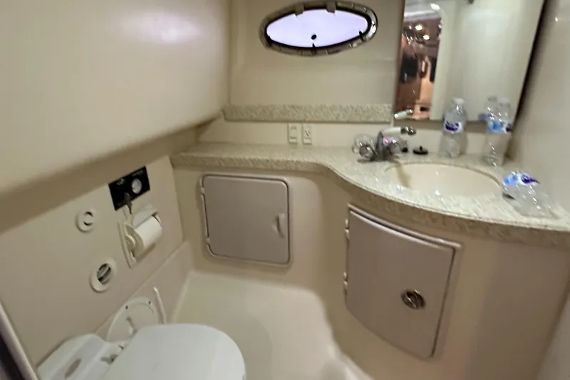 Slide: The Image of 2005 Regal 3350 Sport Cruiser bathroom with sink, toilet, and storage cabinets. - 34