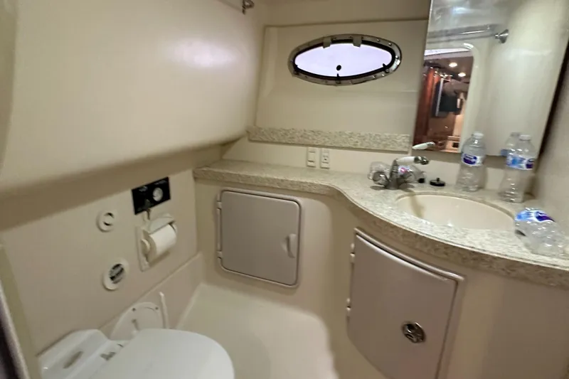 Slide: The Image of 2005 Regal 3350 Sport Cruiser bathroom with sink, toilet, and storage cabinets. - 35