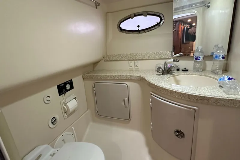 Slide: The Image of 2005 Regal 3350 Sport Cruiser bathroom with sink, toilet, and storage cabinets. - 36