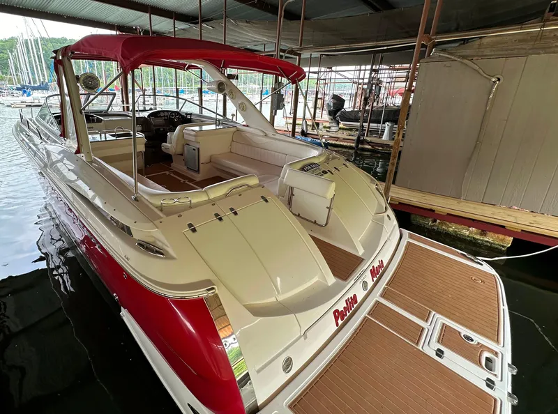 Slide: The Image of 2005 Regal 3350 Sport Cruiser with red canopy docked in marina. - 4