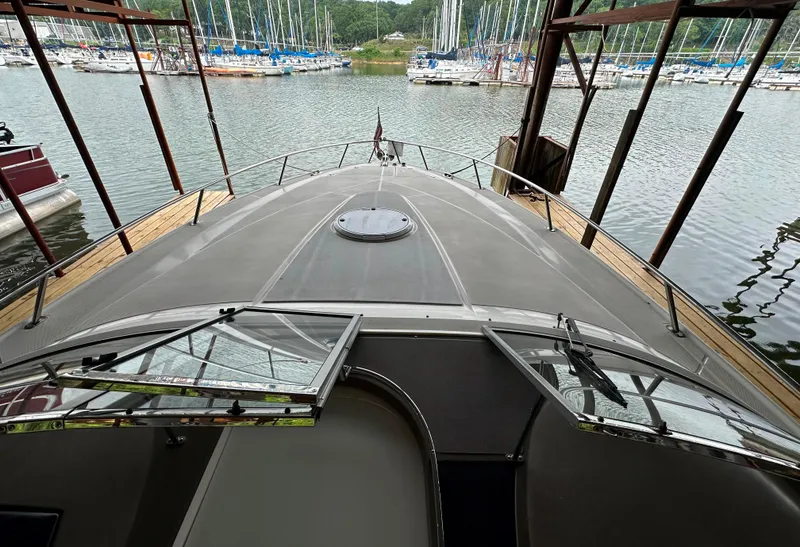 Slide: The Image of 2005 Regal 3350 Sport Cruiser docked at a marina with sailboats in the background. - 9