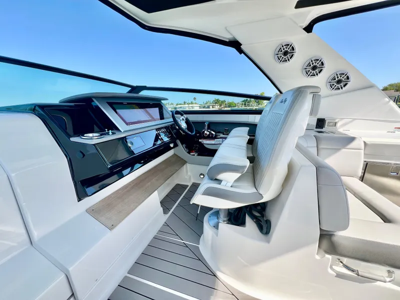 Slide: The Image of 2022 Sea Ray SLX 400 OB helm station with modern controls and seating. - 15