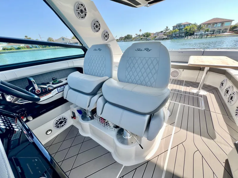 Slide: The Image of 2022 Sea Ray SLX 400 OB boat interior with luxury seating and waterfront view. - 16