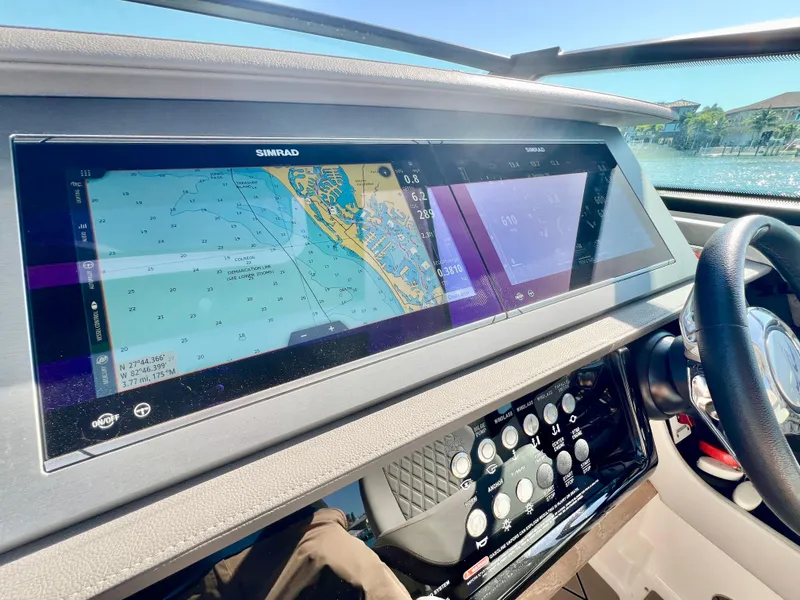 Slide: The Image of Dashboard of 2022 Sea Ray SLX 400 OB with navigation screens and controls. - 17