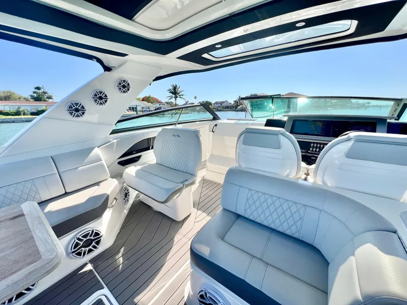 Slide: The Image of 2022 Sea Ray SLX 400 OB luxury boat interior with plush seating and modern design. - 18