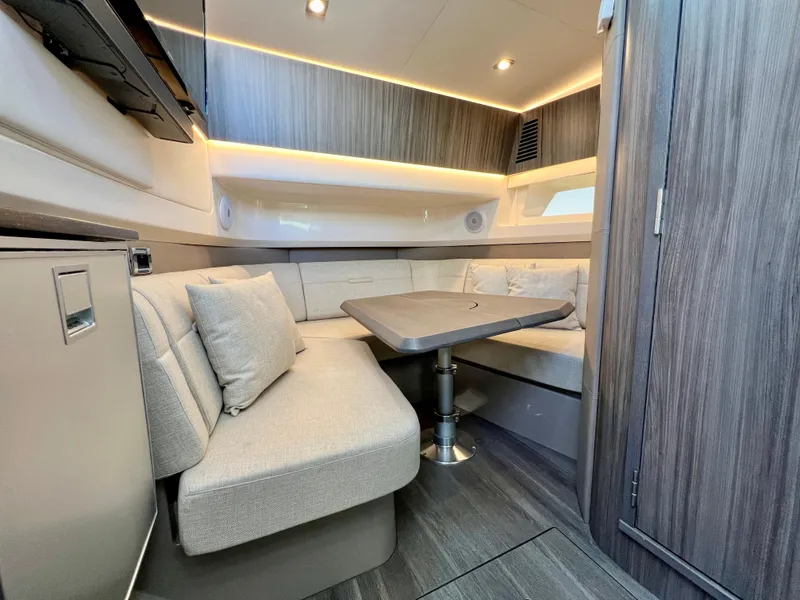 Slide: The Image of 2022 Sea Ray SLX 400 OB cabin interior with modern seating and table. - 20