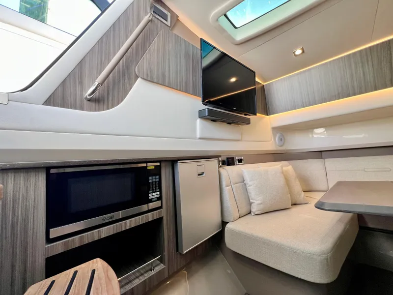 Slide: The Image of Interior of 2022 Sea Ray SLX 400 OB with modern amenities and cozy seating. - 21