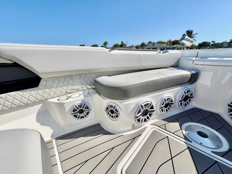 Slide: The Image of 2022 Sea Ray SLX 400 OB boat interior with cushioned seating and built-in speakers. - 27