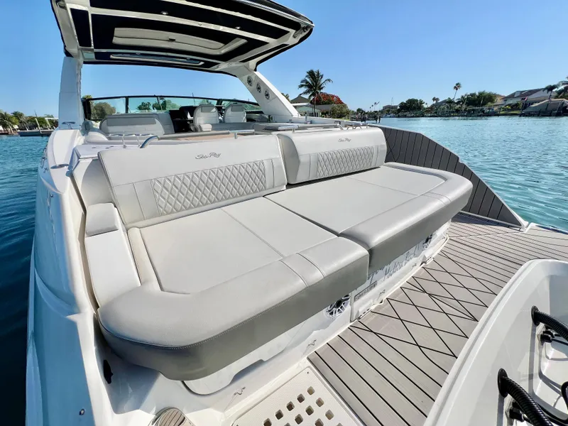 Slide: The Image of 2022 Sea Ray SLX 400 OB luxury boat with spacious seating on a sunny day. - 6
