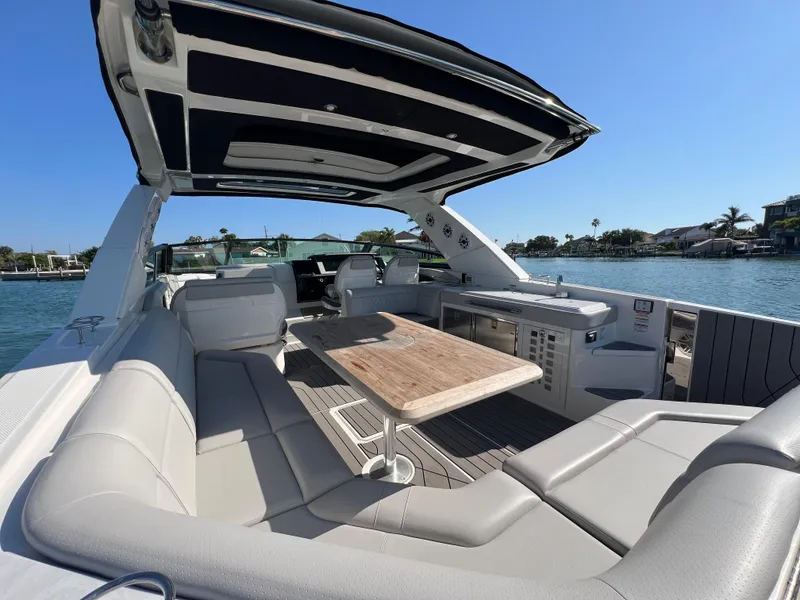 Slide: The Image of 2022 Sea Ray SLX 400 OB luxury boat with spacious seating and dining area. - 7