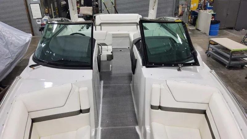 Slide: The Image of 2025 Formula 290 Bowrider boat interior with white seating and dual windshields. - 18