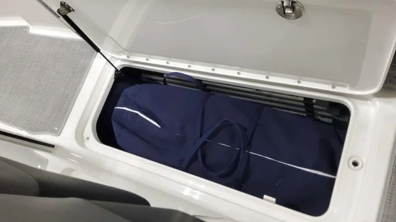 Slide: The Image of 2025 Formula 290 Bowrider storage compartment with blue bag inside. - 21