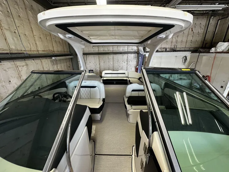 Slide: The Image of Interior of a 2025 Regal 3300 boat with modern seating and glass windshields. - 11