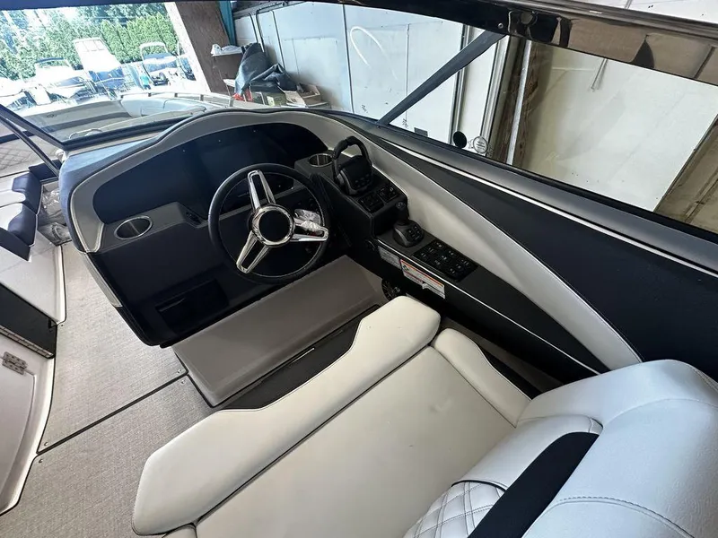 Slide: The Image of Interior cockpit of 2025 Regal 3300 boat with modern steering wheel and controls. - 12
