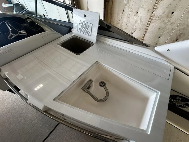 Slide: The Image of 2025 Regal 3300 boat interior with sink and storage compartment. - 13