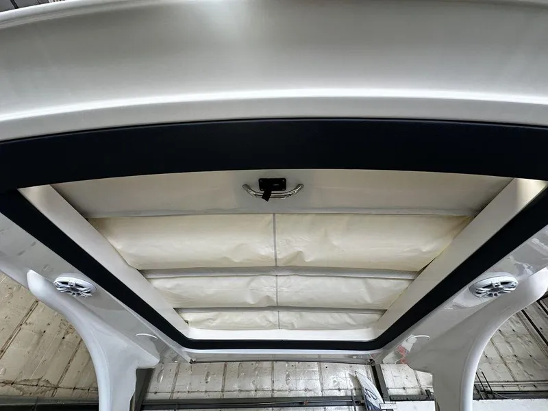 Slide: The Image of 2025 Regal 3300 boat interior ceiling with built-in speakers and lighting. - 15