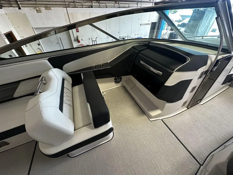 Slide: The Image of Interior of a 2025 Regal 3300 boat with modern seating and dashboard. - 17