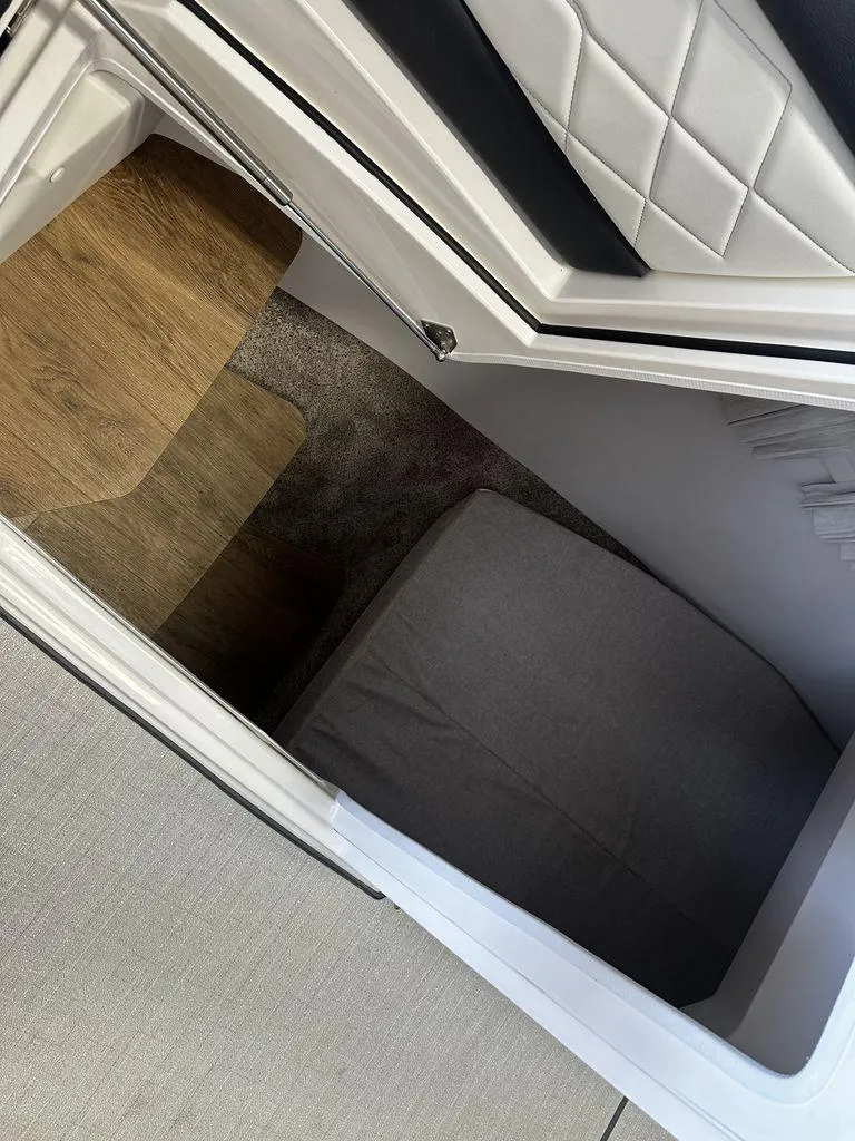 Slide: The Image of 2025 Regal 3300 cabin interior with wood flooring and cushioned seating. - 18