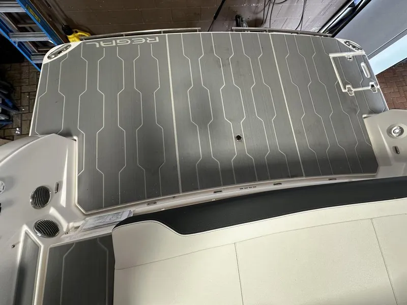 Slide: The Image of Regal 3300 2025 model boat deck with non-slip surface and branding. - 8