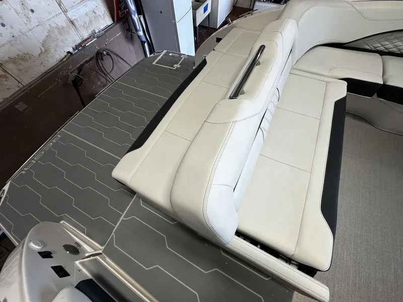 Slide: The Image of 2025 Regal 3300 boat interior with white leather seating and gray flooring. - 9