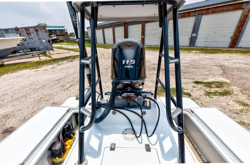 Slide: The Image of 1996 Hewes Tunnel boat with Yamaha 115 outboard motor in a storage yard. - 10