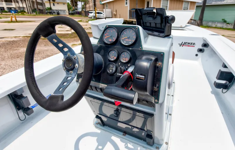 Slide: The Image of 1996 Hewes Tunnel boat console with steering wheel and instrument panel. - 12