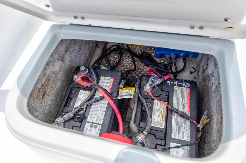 Slide: The Image of Two batteries in the storage compartment of a 1996 Hewes Tunnel boat. - 13