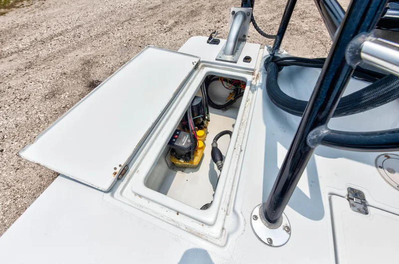 Slide: The Image of Open storage compartment on a 1996 Hewes Tunnel boat showing internal equipment. - 15