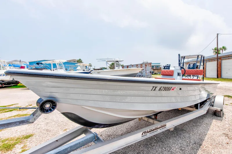 Slide: The Image of 1996 Hewes Tunnel boat on a trailer in a marina. - 3