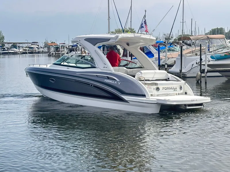 Slide: The Image of 2024 Formula 310 Bowrider I/O cruising in a marina. - 1