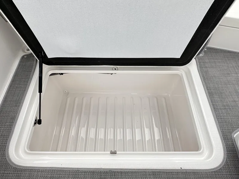 Slide: The Image of Open storage compartment in 2024 Formula 310 Bowrider I/O boat. - 23