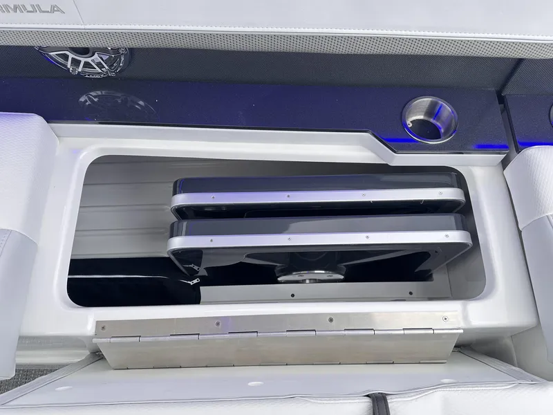 Slide: The Image of 2024 Formula 310 Bowrider I/O storage compartment with stainless steel details. - 25