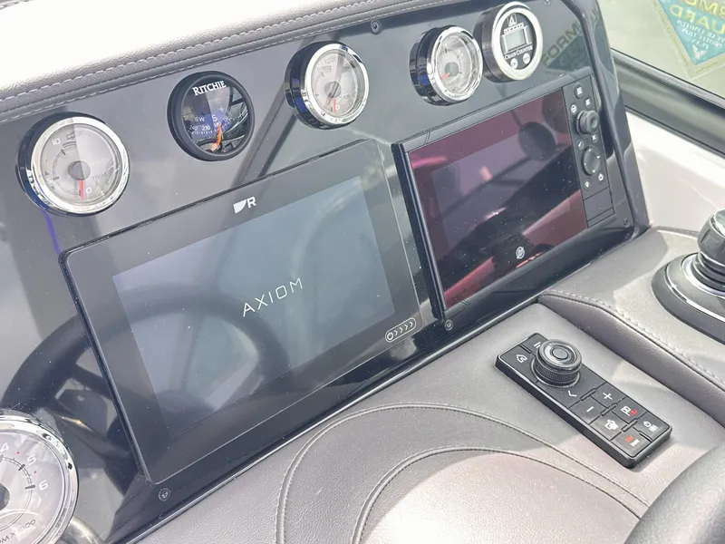 Slide: The Image of 2024 Formula 310 Bowrider I/O dashboard with Axiom display and control panel. - 32