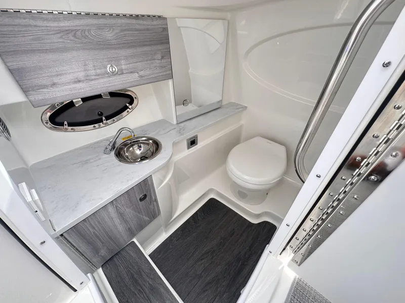 Slide: The Image of 2024 Formula 310 Bowrider I/O boat bathroom with sink, toilet, and storage. - 39