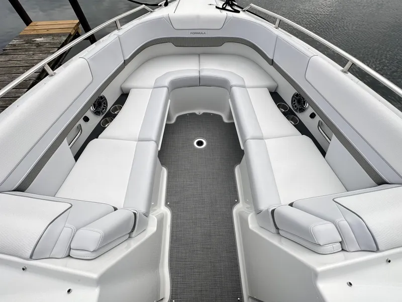 Slide: The Image of 2024 Formula 310 Bowrider I/O with spacious white seating and gray flooring. - 45