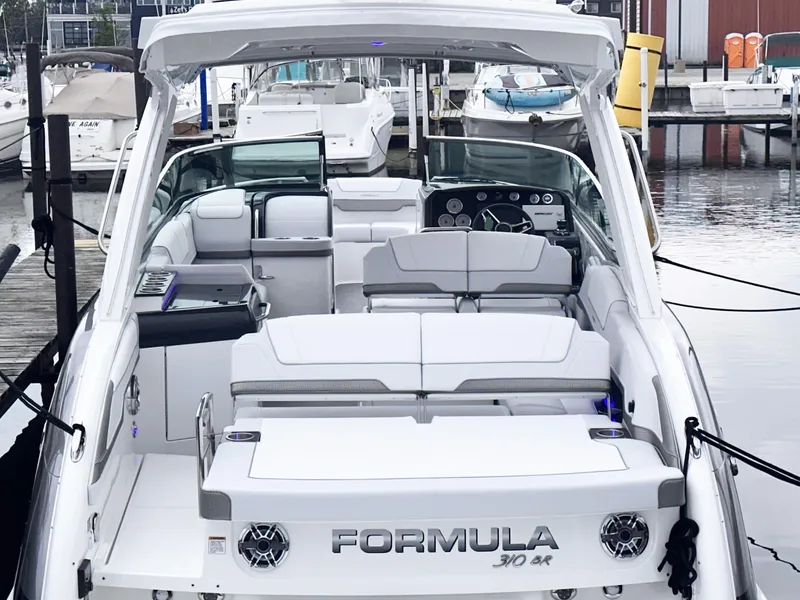 Slide: The Image of 2024 Formula 310 Bowrider I/O luxury boat docked at marina. - 2
