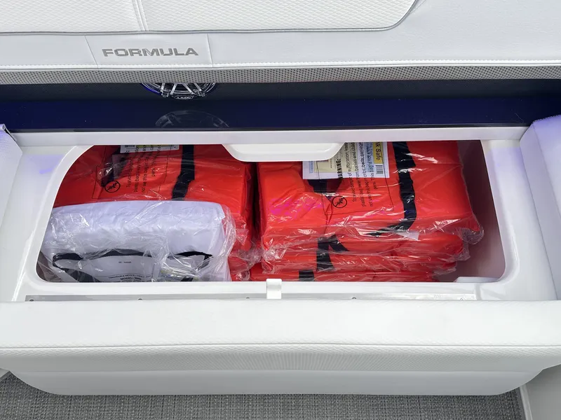 Slide: The Image of Storage compartment with life jackets on a 2024 Formula 310 Bowrider I/O boat. - 20