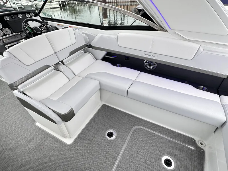 Slide: The Image of 2024 Formula 310 Bowrider I/O interior seating area with modern design and waterfront view. - 26