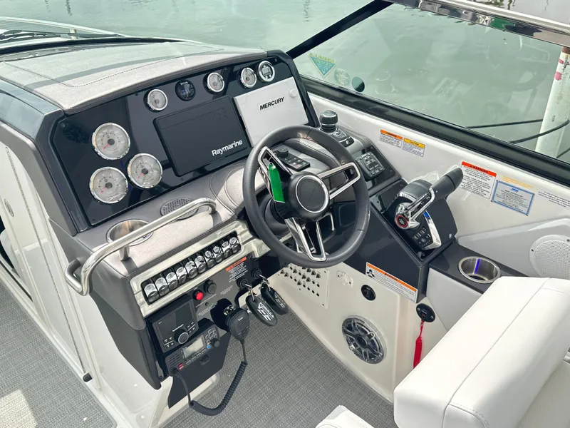 Slide: The Image of 2024 Formula 310 Bowrider I/O dashboard with steering wheel and control panel. - 31