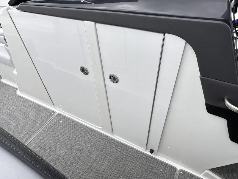 Slide: The Image of 2024 Formula 310 Bowrider I/O storage compartment with sleek white doors and gray flooring. - 40