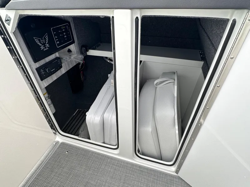 Slide: The Image of 2024 Formula 310 Bowrider I/O storage compartments with cushions and control panel. - 43