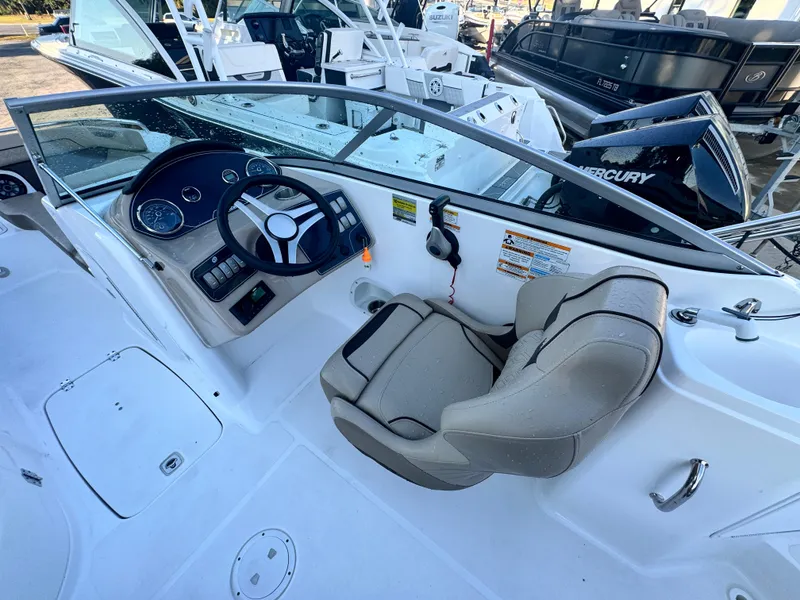 Slide: The Image of 2023 Hurricane SunDeck 2200 DC OB boat interior with steering wheel and seating. - 17